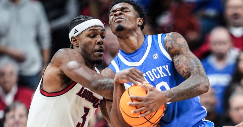 Louisville Cardinals guard Ryan Conwell (3) tussles with Kentucky Wildcats guard Otega Oweh (00) for control in the first half suring the UofL-UK annual rivalry game at the KFC Yum! Center in Louisville, Kentucky Nov. 11, 2025.