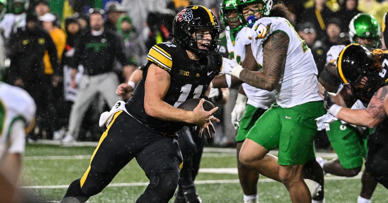 Iowa Hawkeyes quarterback Mark Gronowski (11) runs for a touchdown during the fourth quarter against the Oregon Ducks at Kinnick Stadium
