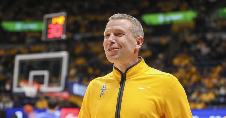 Nov 13, 2025; Morgantown, West Virginia, USA; West Virginia Mountaineers head coach Ross Hodge smiles during pregame introductions before their game against the Pittsburgh Panthers at WVU Coliseum. Mandatory Credit: Ben Queen-Imagn Images