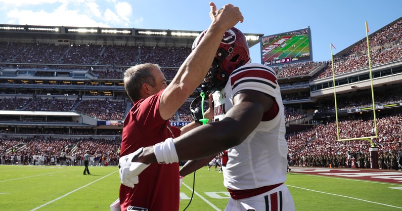 South Carolina Gamecocks wide receiver Nyck Harbor (8) is embraced by head coach Shane Beamer after scoring a touchdown during the second quarter against the Texas A&M Aggies at Kyle Field. Mandatory Credit: Troy Taormina-Imagn Images