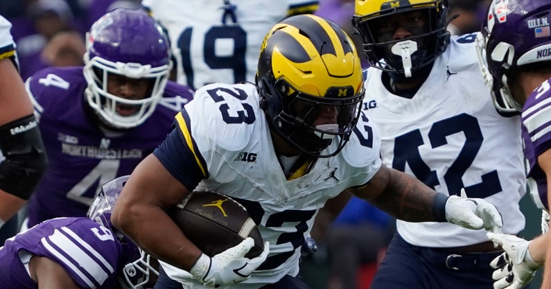 Nov 15, 2025; Chicago, Illinois, USA; Northwestern Wildcats defensive back Braden Turner (9) tackles Michigan Wolverines running back Jordan Marshall (23) during the first half at Wrigley Field. Mandatory Credit: David Banks-Imagn Images