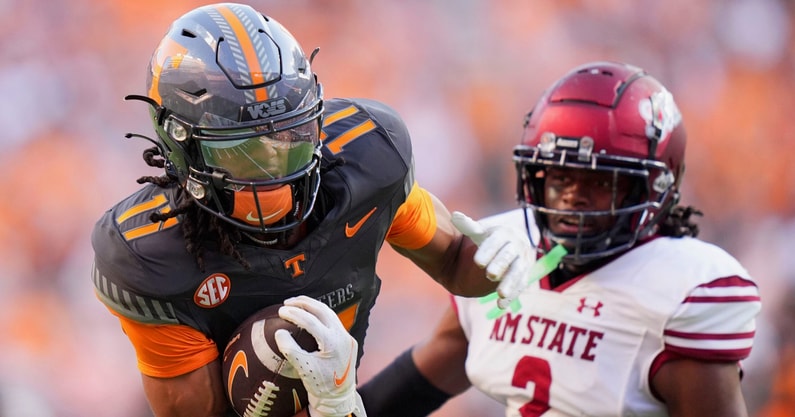 Brianna Paciorka/News Sentinel / USA TODAY NETWORK via Imagn Images | Tennessee running back Peyton Lewis (2) moves the ball while guarded by New Mexico State safety Armahn Hale (2) during an NCAA college football game on November 15, 2025, in Knoxville, Tenn.