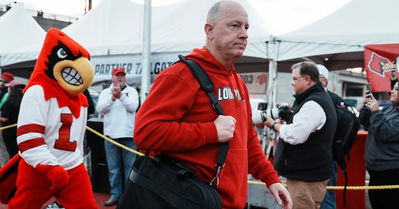 Louisville football coach Jeff Brohm leads the team as the Cards head to the locker room at the Cards March before the Louisville football game against Clemson at L&N Stadium Friday. Nov. 14, 2025
