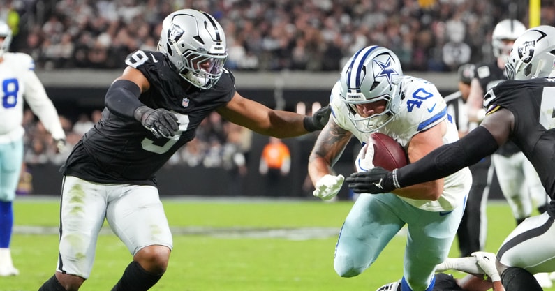 Nov 17, 2025; Paradise, Nevada, USA; Dallas Cowboys running back Hunter Luepke (40) is tackled by Las Vegas Raiders defensive end Tyree Wilson (9) and linebacker Devin White (45) at Allegiant Stadium
