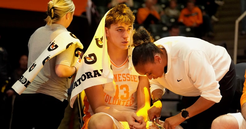 Tennessee forward J.P. Estrella (13) is tended to during the NCAA college basketball game between Tennessee and Rice on November 17, 2025, in Knoxville, Tenn.