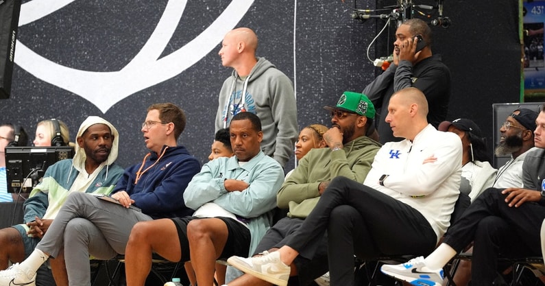 July 19, 2025; North Augusta, South Carolina, USA; NBA star Carmelo Anthony (center right) talks to University of Kentucky basketball coach Mark Pope (right) during the Team Why Not and Team CP3 game at the Nike EYBL Peach Jam at Riverview Park Activity Center. Team Why Not won 66-63. Mandatory Credit: Katie Goodale - Augusta Chronicle/USA TODAY NETWORK