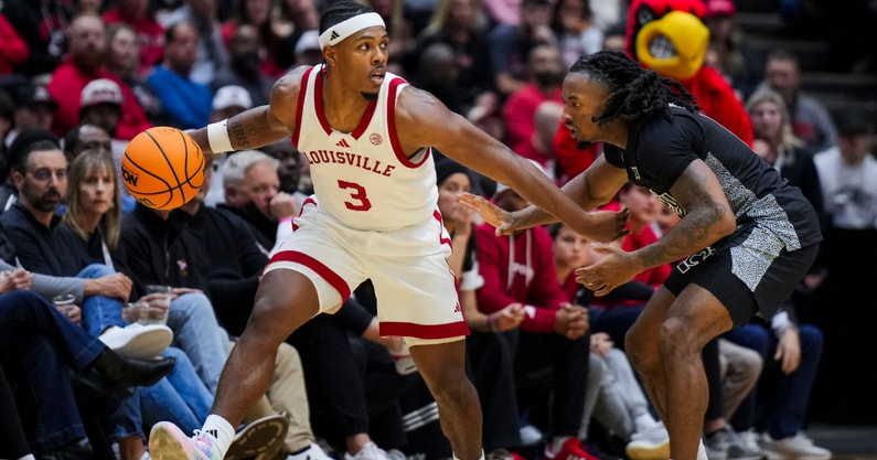 Nov 21, 2025; Cincinnati, Ohio, USA; Louisville Cardinals guard Ryan Conwell (3) dribbles the ball against Cincinnati Bearcats guard Day Day Thomas (1) in the second half at Heritage Bank Center. Mandatory Credit: Aaron Doster-Imagn Images