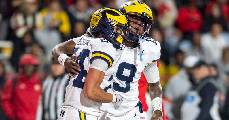 Nov 22, 2025; College Park, Maryland, USA; Michigan Wolverines quarterback Bryce Underwood (19) celebrates with running back Bryson Kuzdzal (24) after scoring a touchdown during the second half against the Maryland Terrapins at SECU Stadium. Mandatory Credit: Tommy Gilligan-Imagn Images