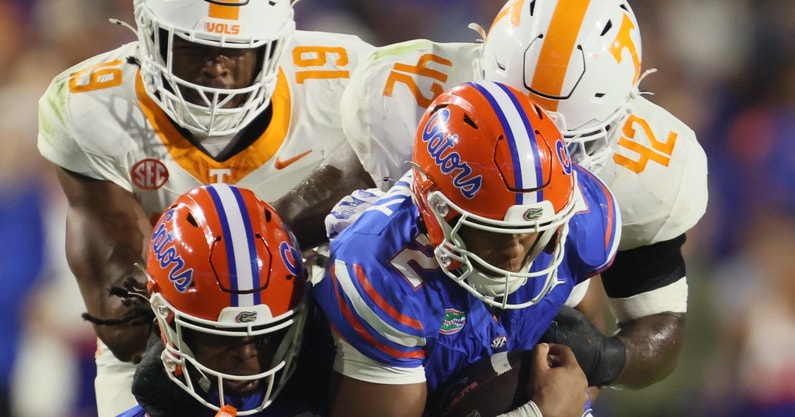 Florida wide receiver TJ Abrams (4) and Florida quarterback DJ Lagway (2) gets snatched off their feet by Tennessee defensive lineman Joshua Josephs (19) and Tennessee defensive lineman Tyre West (42) during the second half of an NCAA football game against Tennessee at Steve Spurrier Field at Ben Hill Griffin Stadium in Gainesville, FL on Saturday, November 22, 2025. Florida lost to Tennessee 31-11[Alan Youngblood/Gainesville Sun]