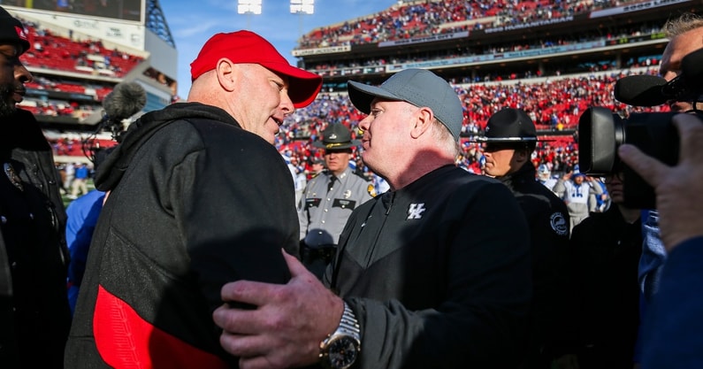 Louisville head coach Jeff Brohm congratulates Kentucky head coach Mark Stoops after the Wildcats beat Louisville 38-31 Saturday and retaining the Governor's Cup. It was Brohm's first Governor's Cup game as head coach for UofL. Nov. 24, 2023. © Matt Stone/The Courier Journal / USA TODAY NETWORK
