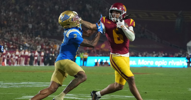 USC Trojans wide receiver Makai Lemon (6) carries the ball against UCLA Bruins defensive back Andre Jordan Jr. (2) in the second half at United Airlines Field at Los Angeles Memorial Coliseum