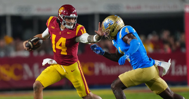 USC Trojans quarterback Jayden Maiava (14) carries the ball against UCLA Bruins defensive back Key Lawrence (4) in the second half at United Airlines Field at Los Angeles Memorial Coliseum