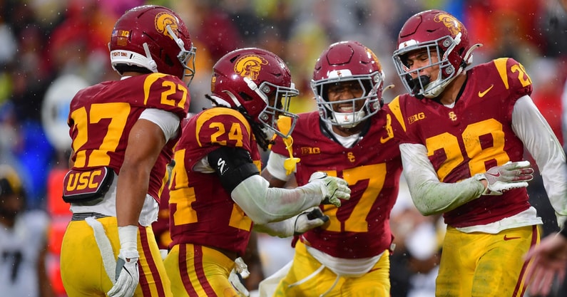 USC Trojans cornerback Alex Graham (27) safety Christian Pierce (24) cornerback Decarlos Nicholson (17) and safety Kennedy Urlacher (28) celebrate after Iowa Hawkeyes turn the ball over on fourth down during the second half at the Los Angeles Memorial Coliseum