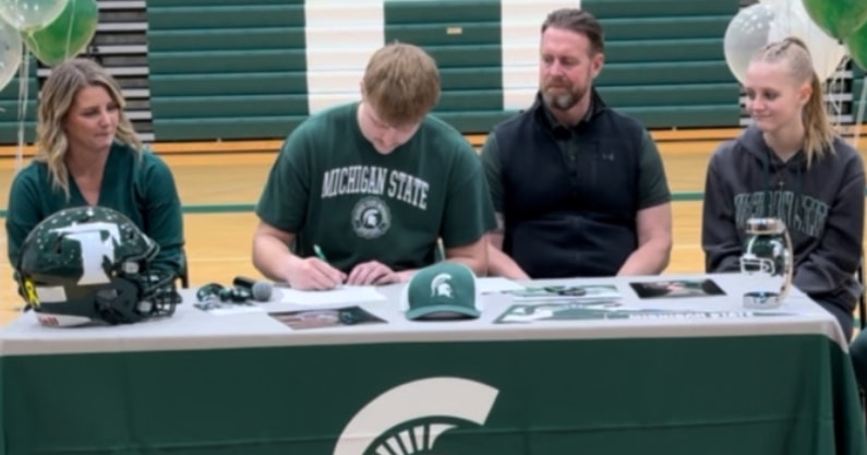 Michigan State offensive tackle signee Tristan Comer with his family on signing day (photo by Kenny Jordan for SpartanMag.com).