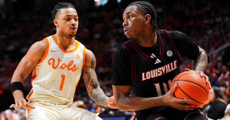 Louisville guard Adrian Wooley (14) is defended by Tennessee guard Amari Evans (1) during a college basketball game between Tennessee and Louisville held at Thompson-Boling Arena at Food City Center in Knoxville, Tenn., on Dec. 16, 2025.