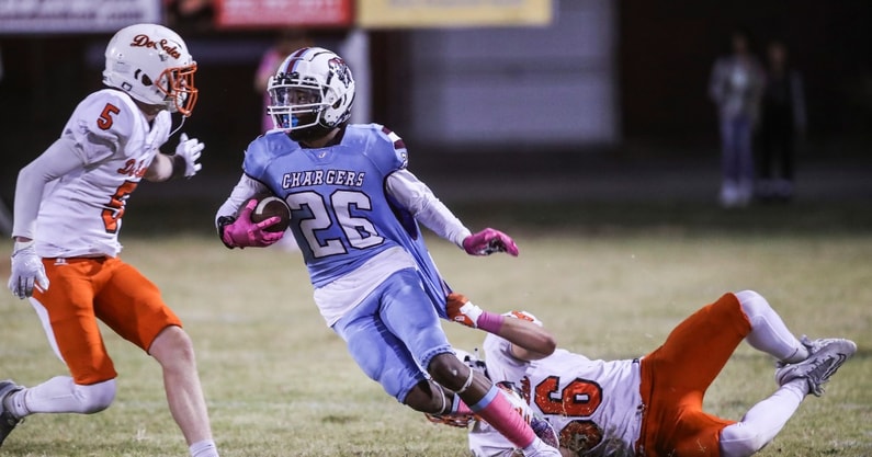 JTown's Larron Westmoreland looks for room to run as DeSale's Michael Ellis tries to make the stop in the fourth quarter Thursday night. The Colts defeated the unbeaten Chargers 21-18. Oct. 12, 2023. © Matt Stone/Louisville Courier Journal / USA TODAY NETWORK