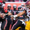 Cameron Rising #7 of the Utah Utes rushes the ball away from Tyrone Taleni #31of the USC Trojans during the first half of their game October 15, 2022 Rice-Eccles Stadium in Salt Lake City Utah. (Photo by Chris Gardner/ Getty Images)