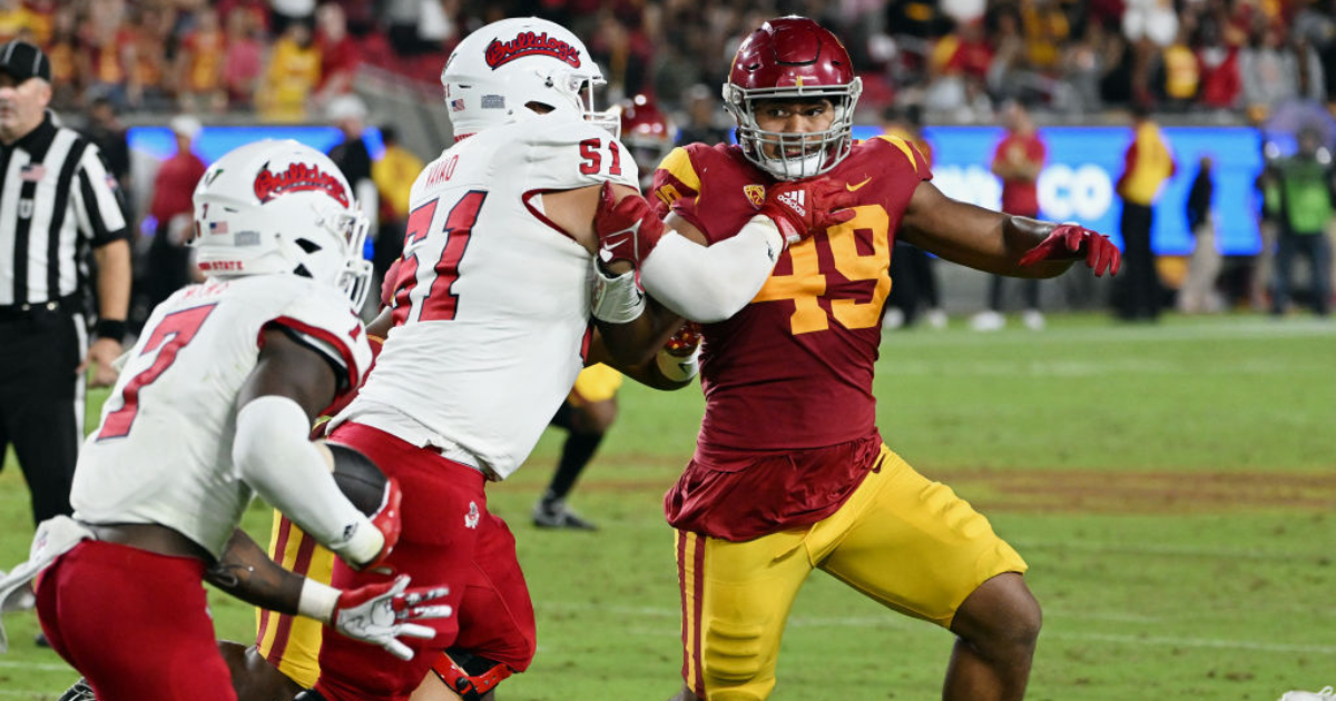 USC Trojans defensive lineman Tuli Tuipulotu (49) chases the running back while being blocked by Fresno State Bulldogs defensive lineman Charles Remlinger (51) during an NCAA football game against the Bulldogs played on September 17, 2022 at the Los Angel