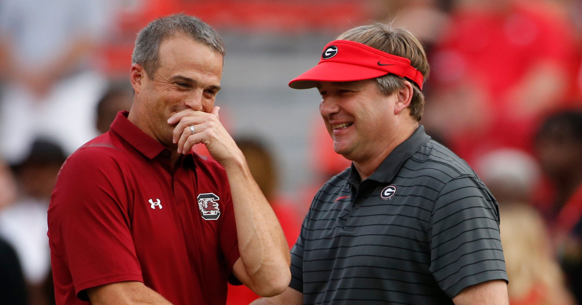 South Carolina head coach Shane Beamer meets with Kirby Smart before the game in Athens in 2021