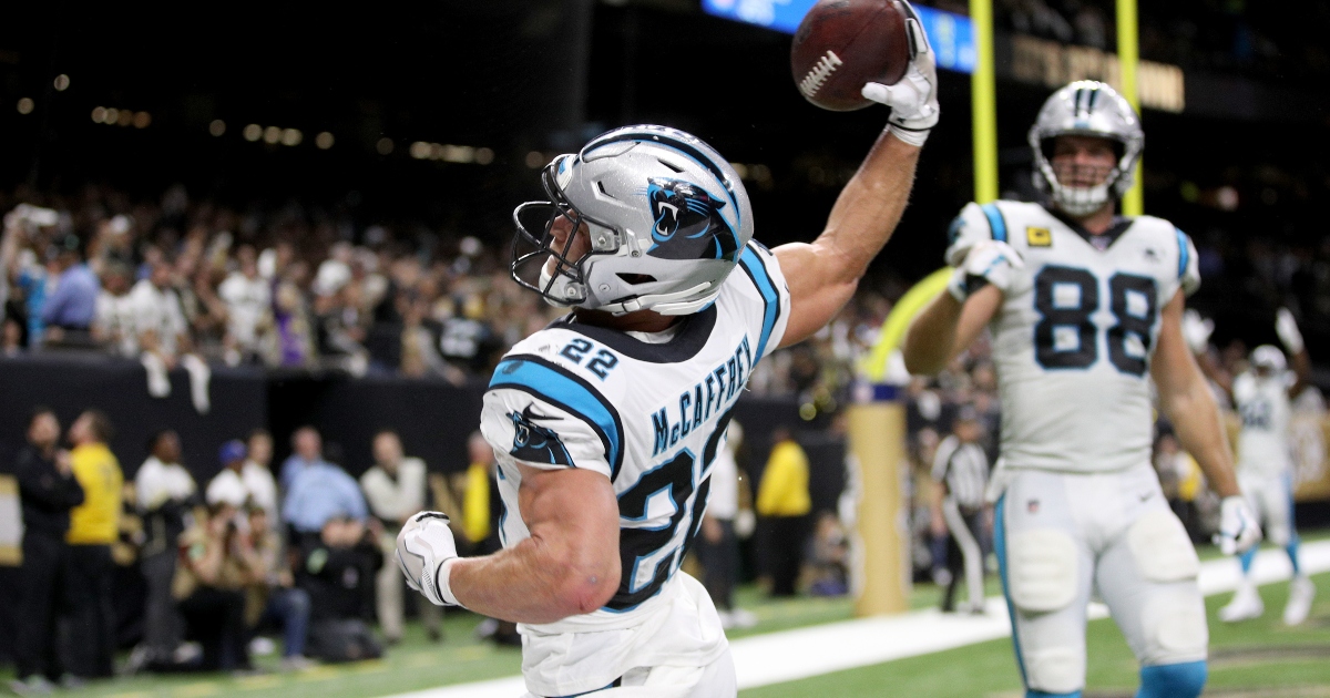 Christian McCaffrey of the Carolina Panthers jumps over Tre