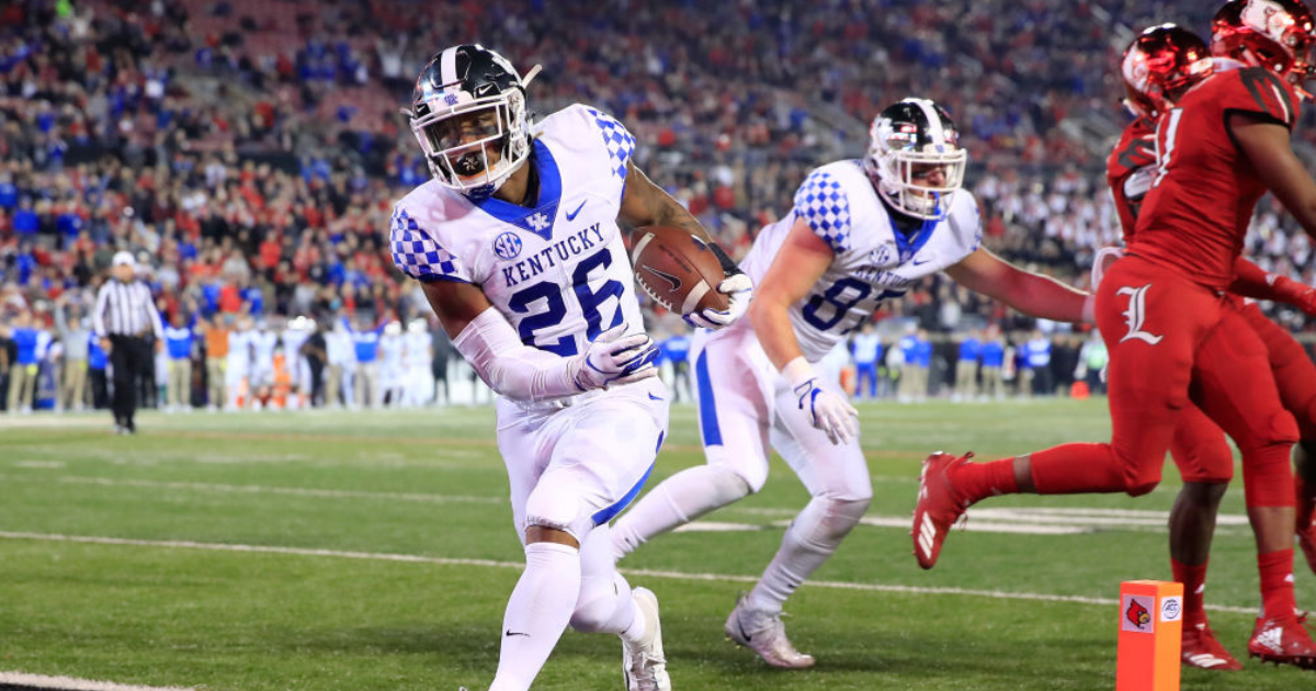 Kentucky running back Benny Snell Jr. , his face wrapped in a scarf, greets  fans before the