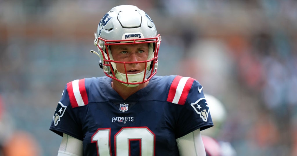 New England Patriots quarterback Mac Jones (10) walks off the