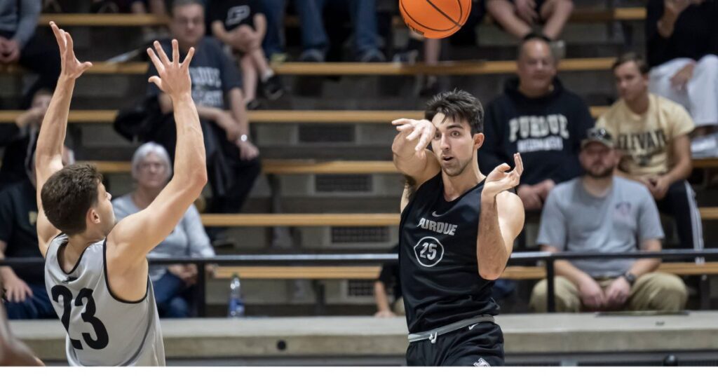 Purdue's Ethan Morton passes the basketball.