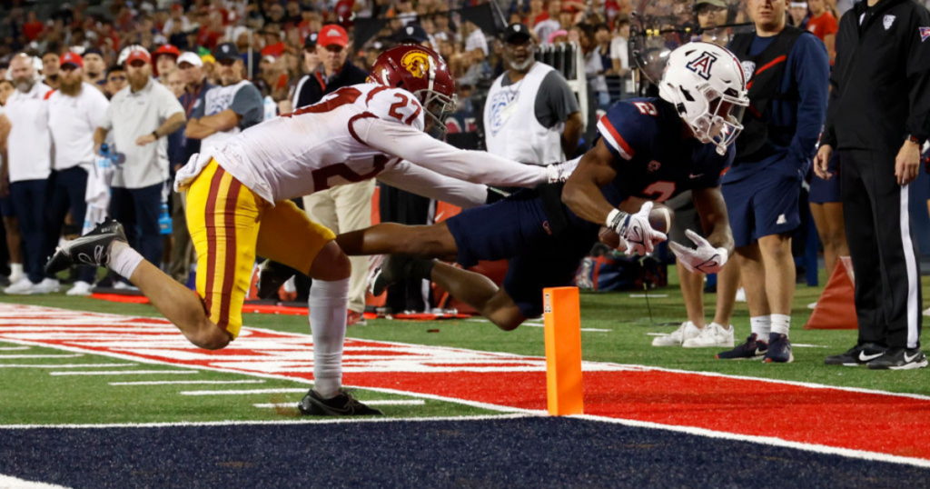 Wide receiver Jacob Cowing #2 of the Arizona Wildcats scores on a two point conversion attempt while being tackled by defensive back Bryson Shaw #27 of the USC Trojans during the second half at Arizona Stadium