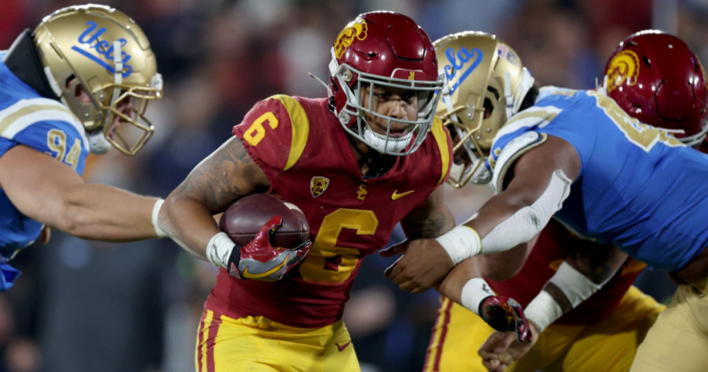 Austin Jones #6 of the USC Trojans runs the ball against the UCLA Bruins during the second quarter in the game at Rose Bowl