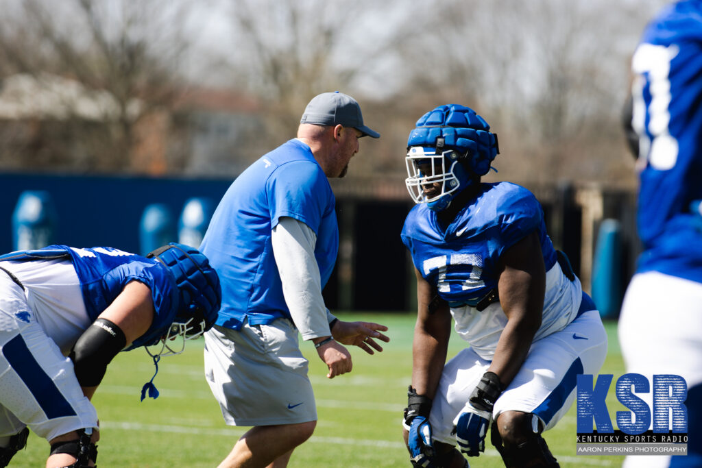 Kentucky offensive lineman Jeremy Flax receives instruction at an open practice