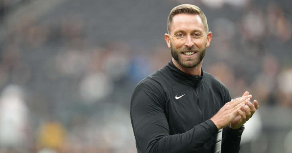 Head coach Kliff Kingsbury interacts with players during warmups before a game against the Las Vegas Raiders
