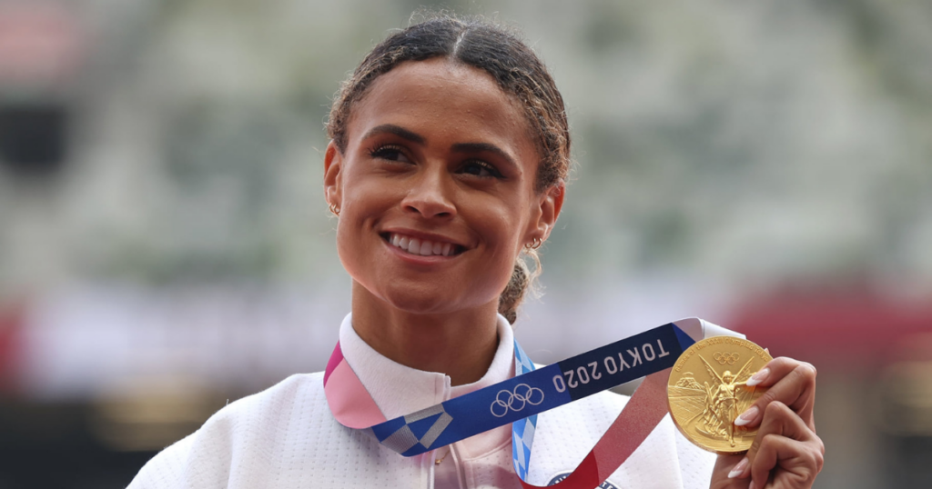 Former Kentucky track star Sydney McLaughlin poses with her gold medal at the Tokyo Olympics - Christian Petersen/Getty Images