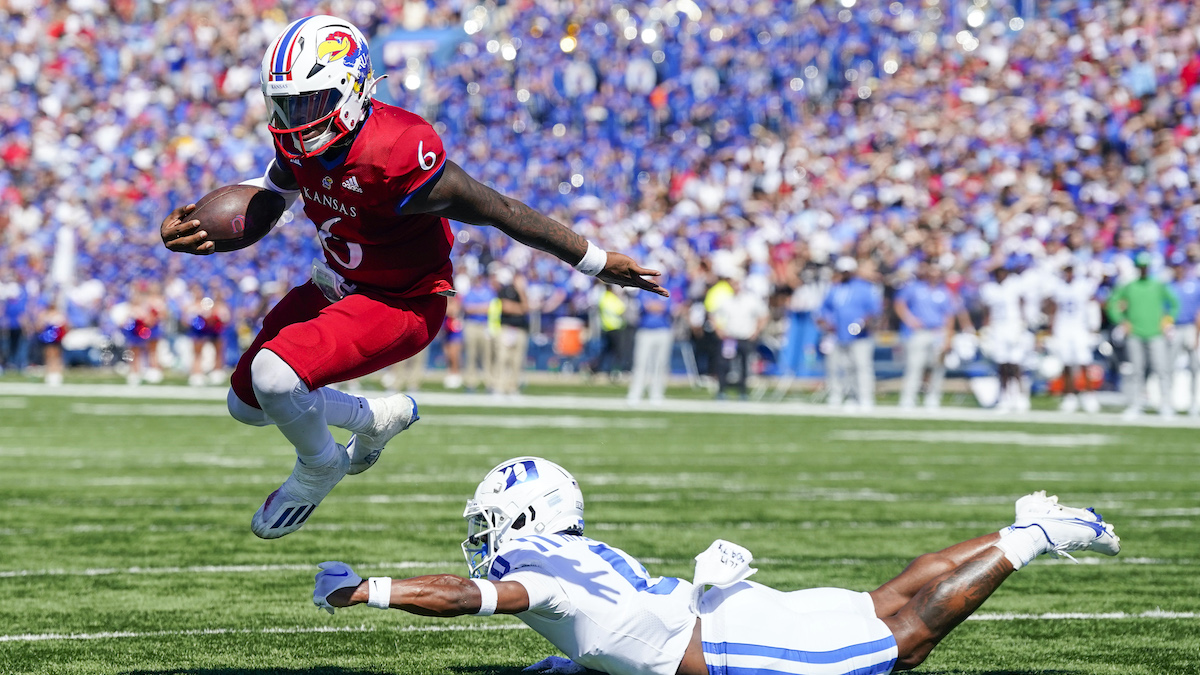 Kansas quarterback Jalon Daniels shows off Cuban link chain with pendant playing videos of his highlights