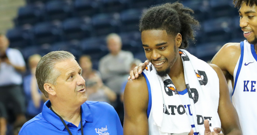 Kentucky head coach John Calipari (left) celebrating winning a gold medal next to shooting guard Antonio Reeves
