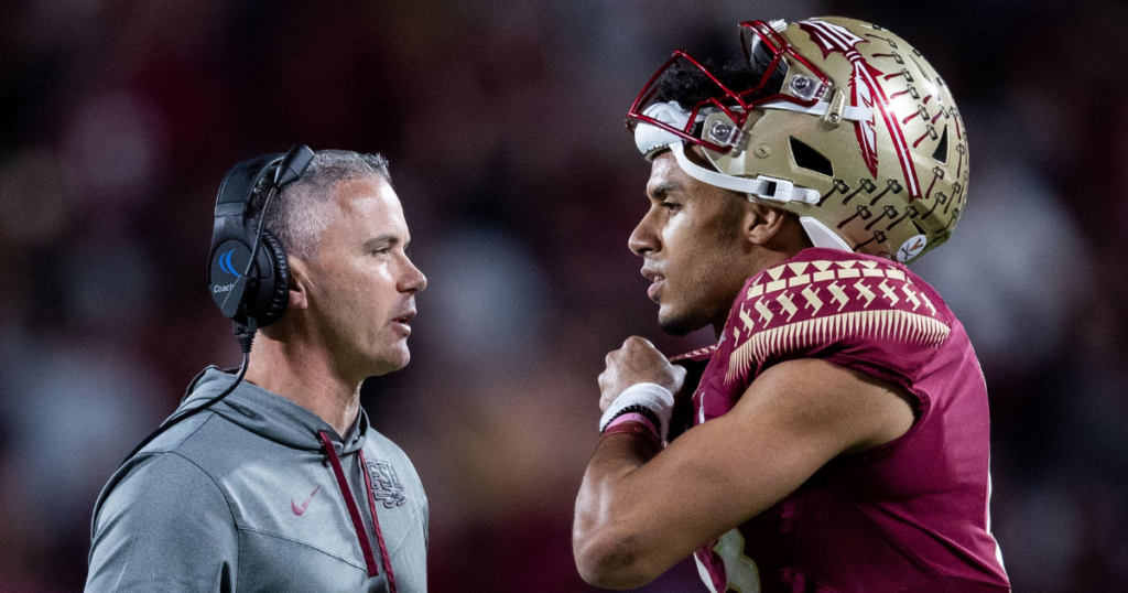 Florida State Seminoles head coach Mike Norvell and Florida State Seminoles quarterback Jordan Travis (13) talk in between plays. The Florida State Seminoles defeated the Oklahoma Sooners 35-32 in the Cheez-It Bowl at Camping World Stadium on Thursday, Dec. 29, 2022.
