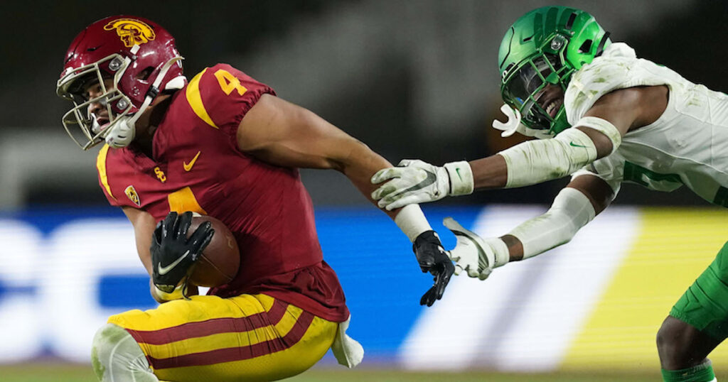 USC Trojans wide receiver Bru McCoy is defended by Oregon Ducks cornerback Mykael Wright