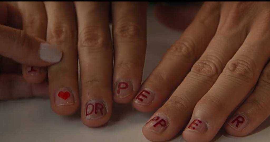 USC quarterback Caleb Williams showcases his finger nails painted with Dr. Pepper during a Dr. Pepper Fansville ad