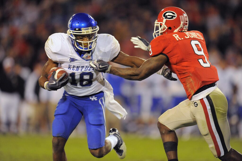 November 21, 2009; Athens, GA, USA; Kentucky Wildcats wide receiver Randall Cobb (18) breaks a tackle by Georgia Bulldogs safety Reshad Jones (9) in the fourth quarter at Sanford Stadium. Kentucky defeated Georgia 34-27.