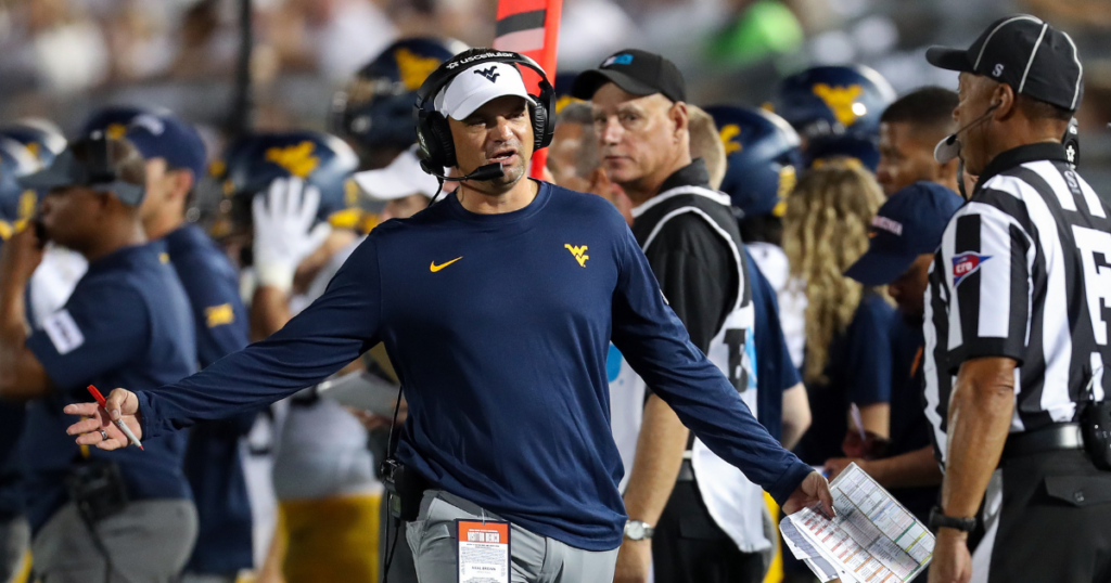 Sep 2, 2023; University Park, Pennsylvania, USA; West Virginia Mountaineers head coach Neal Brown argues a call with a referee during the third quarter against the Penn State Nittany Lions at Beaver Stadium. Penn State defeated West Virginia 38-15.