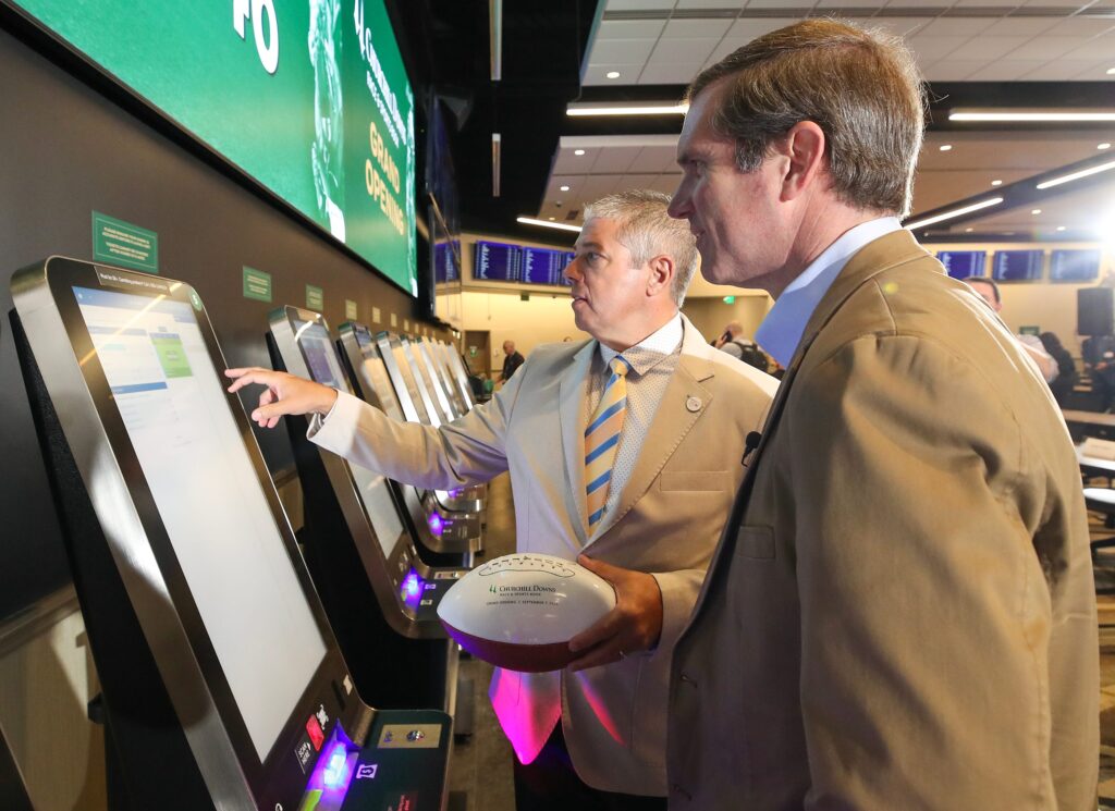 Andy Beshear places a sports gambling wager at Churchill Downs