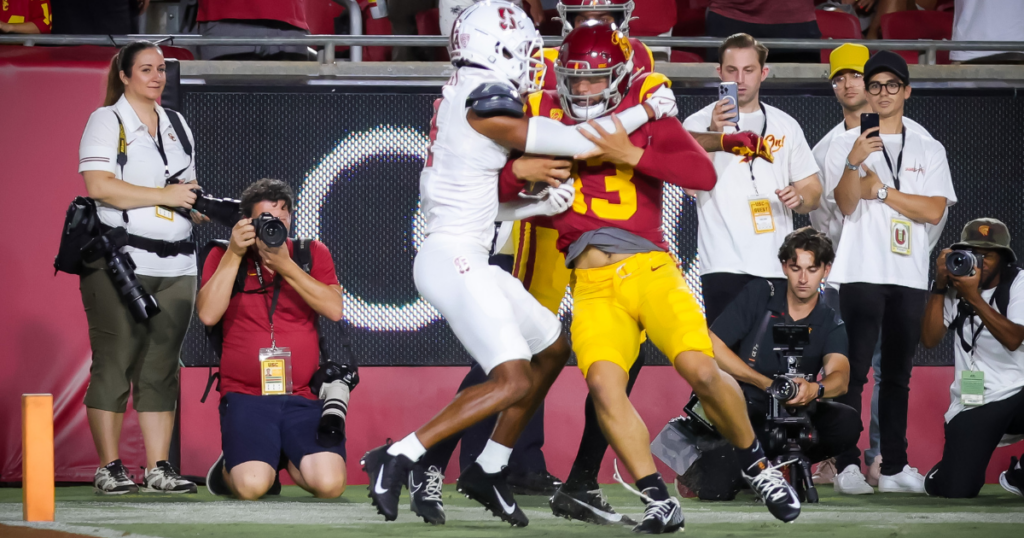 USC quarterback Caleb Williams bullies his way over a Stanford defensive back for a touchdown