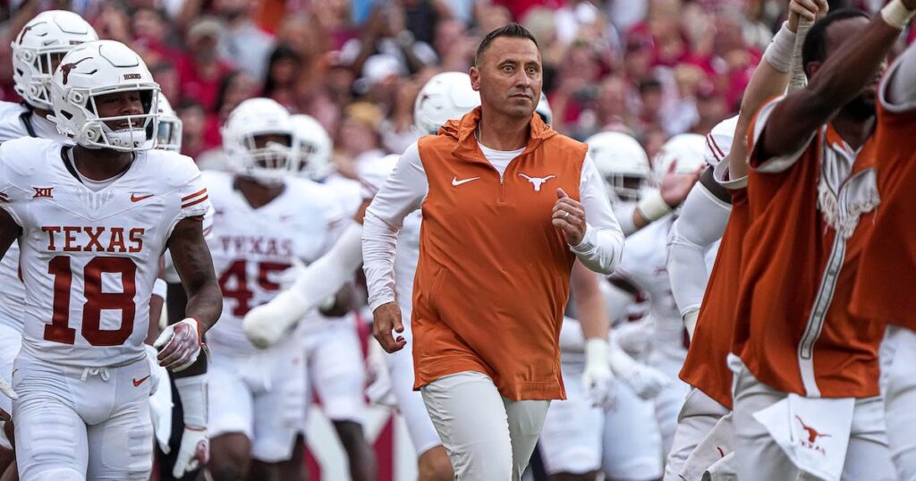 Texas Longhorns head coach Steve Sarkisian leads his team onto the field