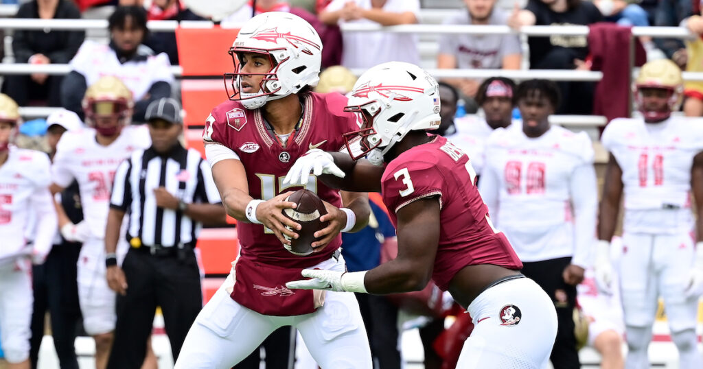 Florida State Seminoles quarterback Jordan Travis hands the ball off to running back Trey Benson d