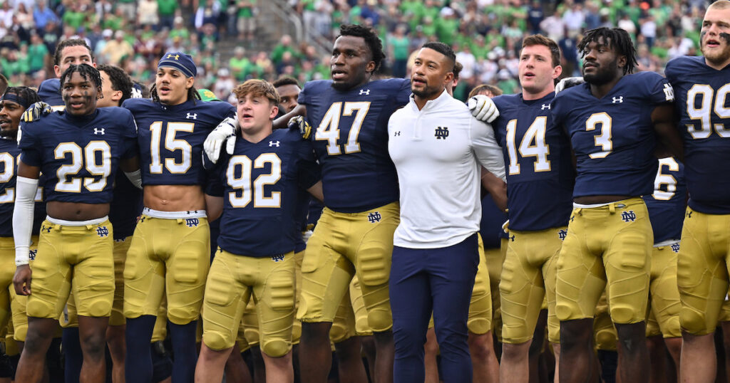 Notre Dame Fighting Irish head coach Marcus Freeman stands with his team for the Notre Dame Alma Mater