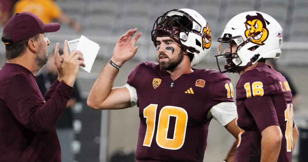 Arizona State Sun Devils offensive coordinator Beau Baldwin talks to his quarterbacks Drew Pyne and Trenton Bourguet during pregame warmups