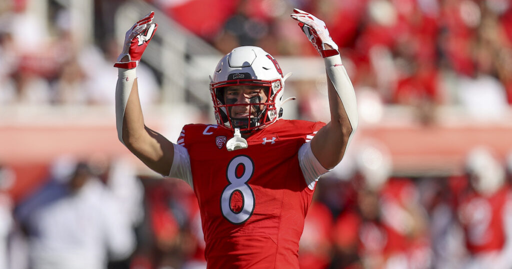 Utah Utes safety Cole Bishop encourages the fans to cheer during a third down
