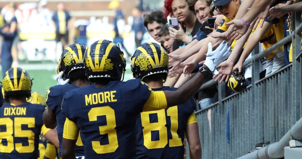 Michigan Wolverines players take the field