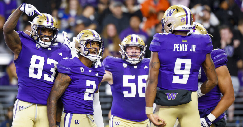 Washington Huskies wide receiver JaLynn Polk (2) celebrates with tight end Devin Culp (83), offensive lineman Geirean Hatchett (56) and quarterback Michael Penix Jr. (9)