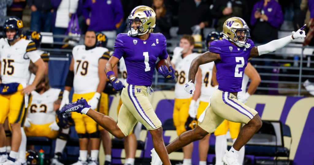 Rome Odunze (1) returns a punt for a touchdown against the California Golden Bears while under escort from wide receiver JaLynn Polk (2) during the first quarter at Alaska Airlines Field at Husky Stadium. 