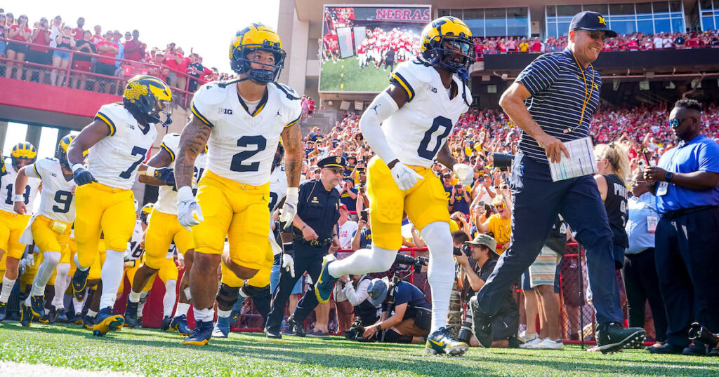 The Michigan Wolverines run onto the field